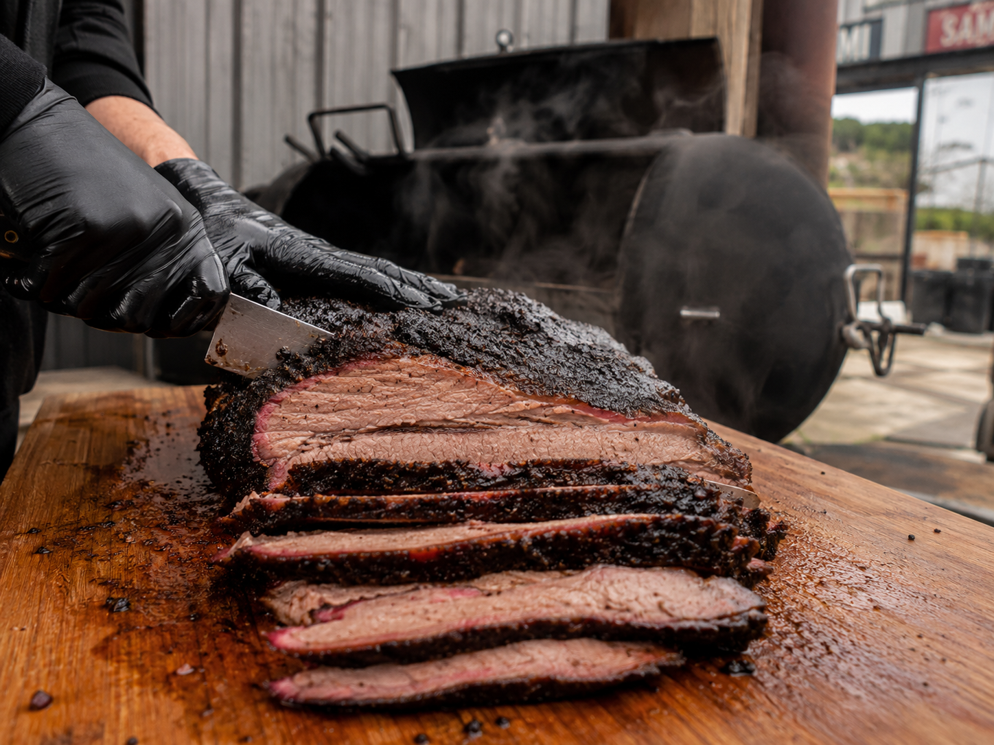 Slicing finished brisket showing a deep smoke ring